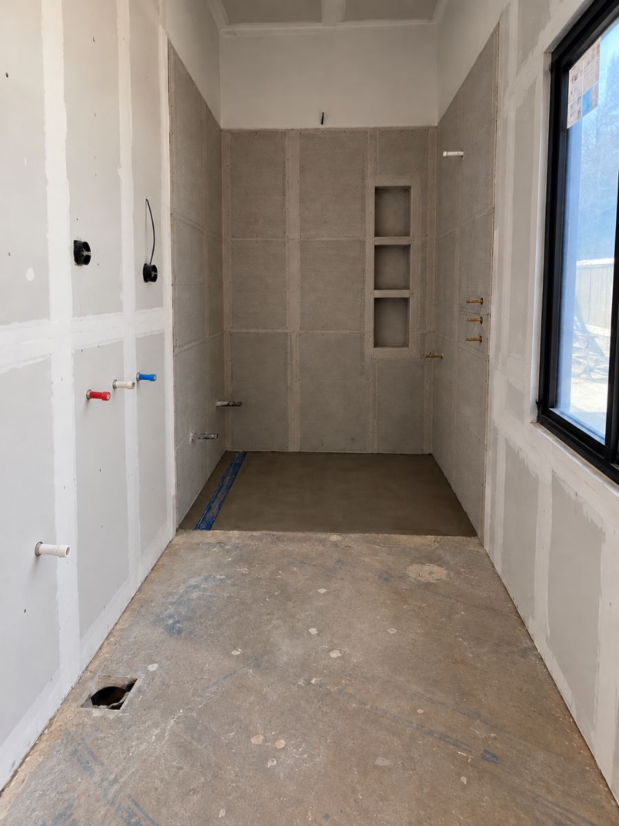 Primary bath at rough-in with cement board, niche framing and mortar shower bed